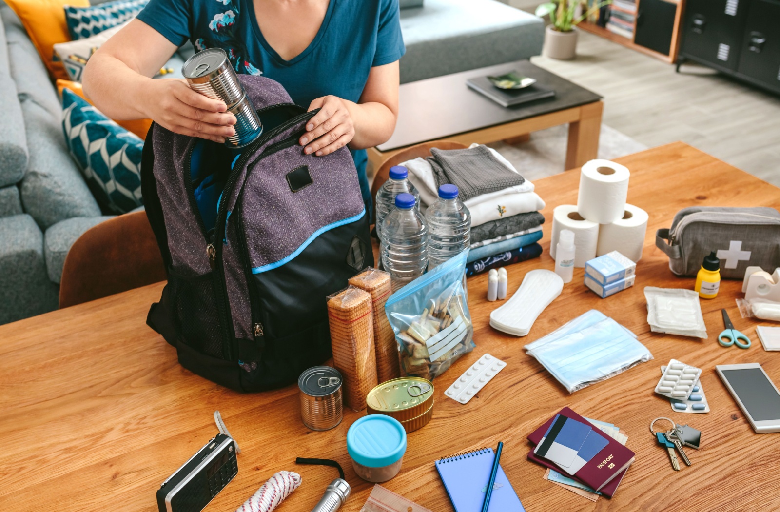 An older adult puts together a hurricane preparedness kit.